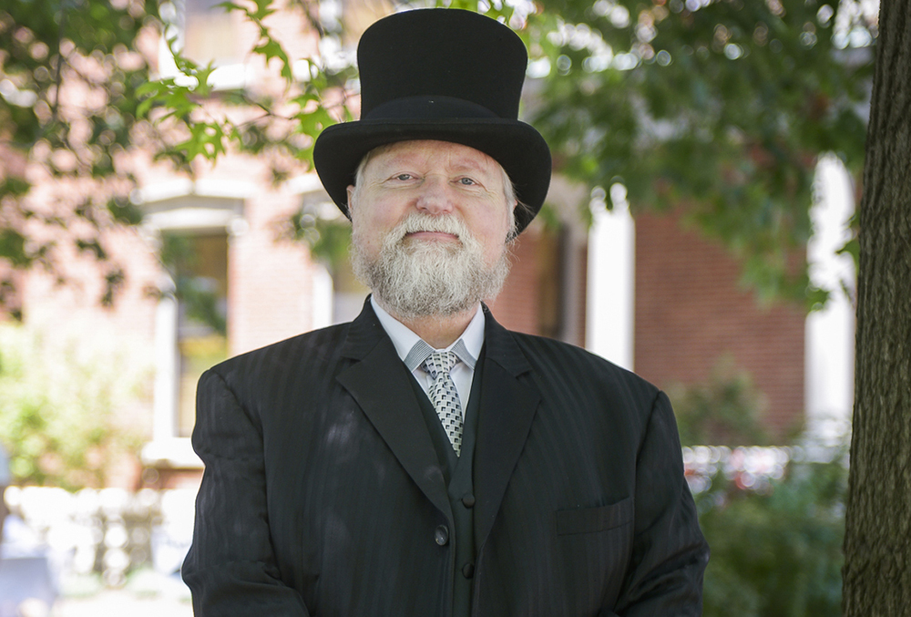 Photograph of Harrison reenactor, posing in front of the mansion.