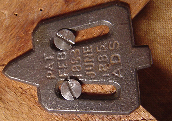 Oil on canvas by Lilly M. Spencer (Lilly Martin Spencer) of Caroline Scott Harrison in profile view. Spencer signature is in lower left (not visible when portrait is in frame). Many engravings and prints were made from this image of Caroline Harrison. She is wearing a dark dress with white lace trim at the high neck, gold earrings, and hair is pulled back in a bun. Background is green in varying dark to medium shades. Pat. date of 1885 on metal corner brackets of wooden stretcher.