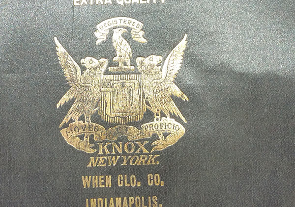 imprinted in gold inside on the top is ‘Extra Quality centered over a mark/symbol – the word Registered on banner over a bird with wings next to body, which is over a shield with a bird on each side with wings extended sitting on a banner/ribbon with the words Moveo et Proficio printed; the word KNOX is under the banner; New York on the line beneath; under the shield on two lines is ‘When Col. Co. Indianapolis.’