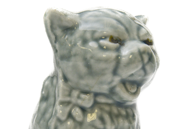 Cat figurine that says 