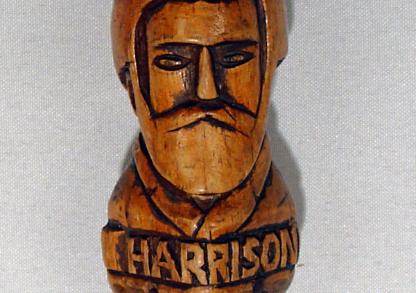 Centennial walking stick, contains hand carved images (head and shoulders in relief) of all the Presidents from Washington to Benjamin Harrison with name below each. They are on both sides of the cane coming down to Harrison. Wood is white pine and stained. The carved handle is an animal head design. Three of the president's names are misspelled: Madison, Hayes, and Arthur.