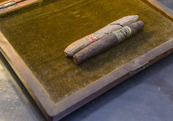 Wooden cigar box with inlaid top that says 