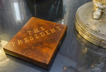 Wooden cigar box with inlaid top that says 