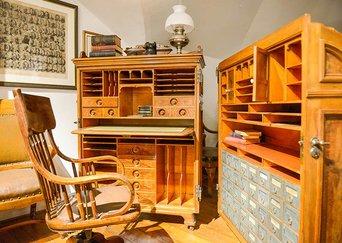Image of a desk with many cubbyholes and compartments. The desk has two sides that can close together like a clamshell.