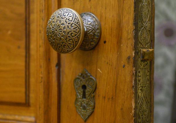 Ornate Victorian door knob at the Benjamin Harrison Presidential Site. The door knob is engraved with an intricate pattern featuring detailed curves and shapes.