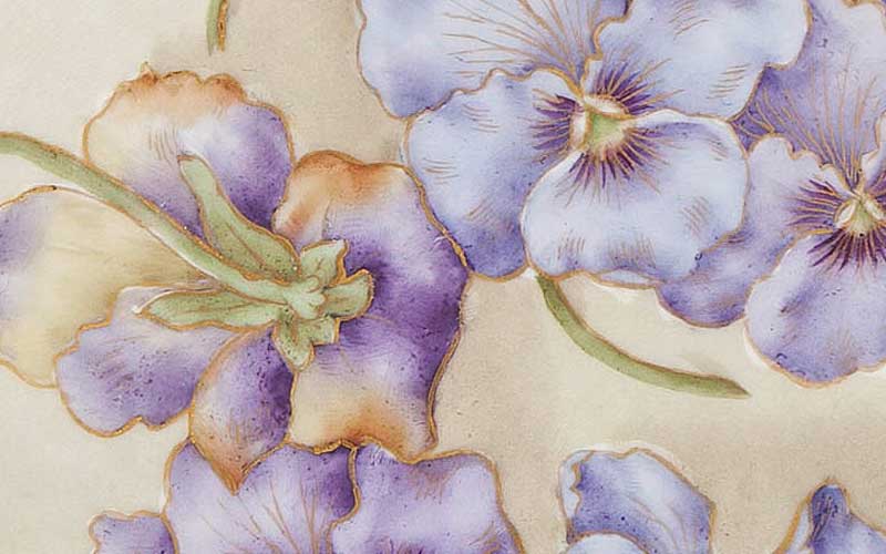 Designed and hand-painted by Mrs. Caroline Scott Harrison with hand painted purple and lavender Pansies. Edge is a cutout lace pattern with gold paint.