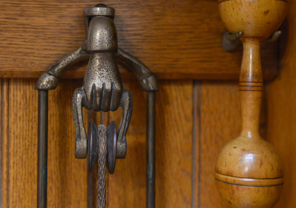 Oak case with iron dumbbell shaped weights (5) on ropes to be pulled, eight sets of wooden dumbbells and pair of Indian clubs. Metal plate: 
