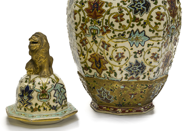 Matched pair of porcelain rose jars (Potpourri jars) with octagon shape, so called as they were filled with dried rose petals. They are Hungarian and have a gold lion on top. The lions are painted with a rough finish gold paint. They have their mouths open and one paw up on a bright and smooth gold ball. Ornately painted with red, blue, and dark yellow flowers with green leaves and vines on white background with gold trim at top.