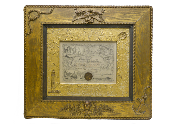 Framed Certificate New York Marine Society in wooden frame. Embellishments on frame: eagle at top center, rope knot in upper left corner, anchor and rope in lower right corner, bust of George Washington with leaf and berry design around Washington. Inner frame wooded frame is gold leaf and a shell in upper right and lighthouse on lower left. The outside edge of the frame is rope painted and linked chain design on inner part of outer frame. 9