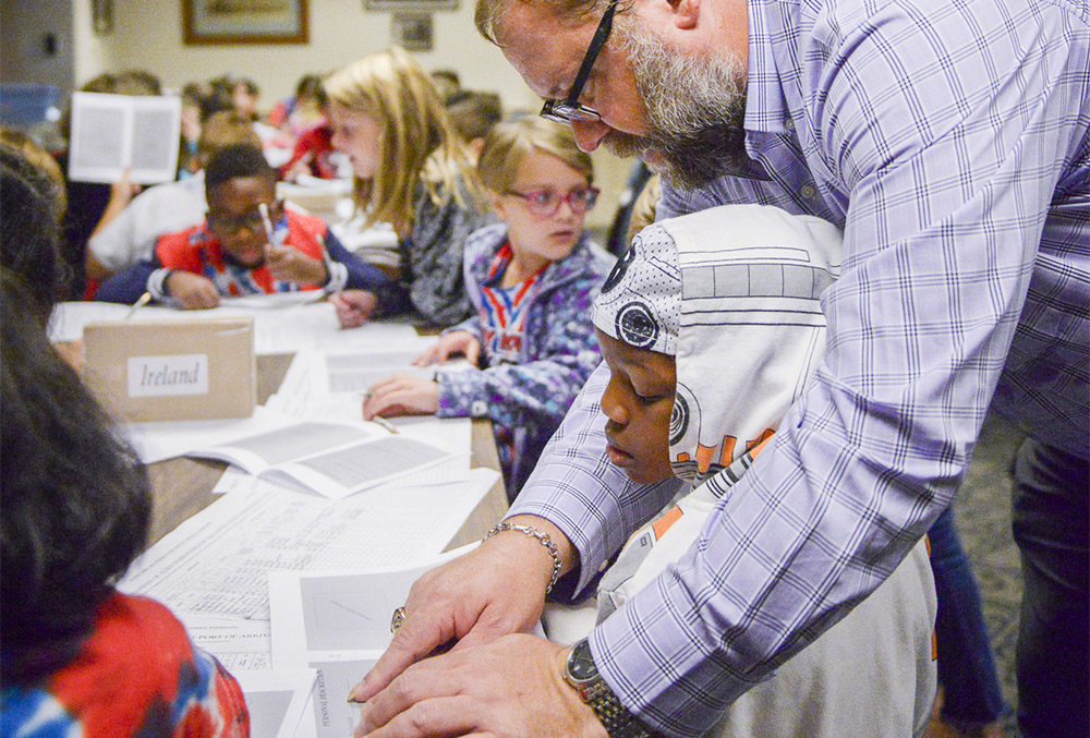 Photo of Roger Hardig giving individual attention to a student during a program.